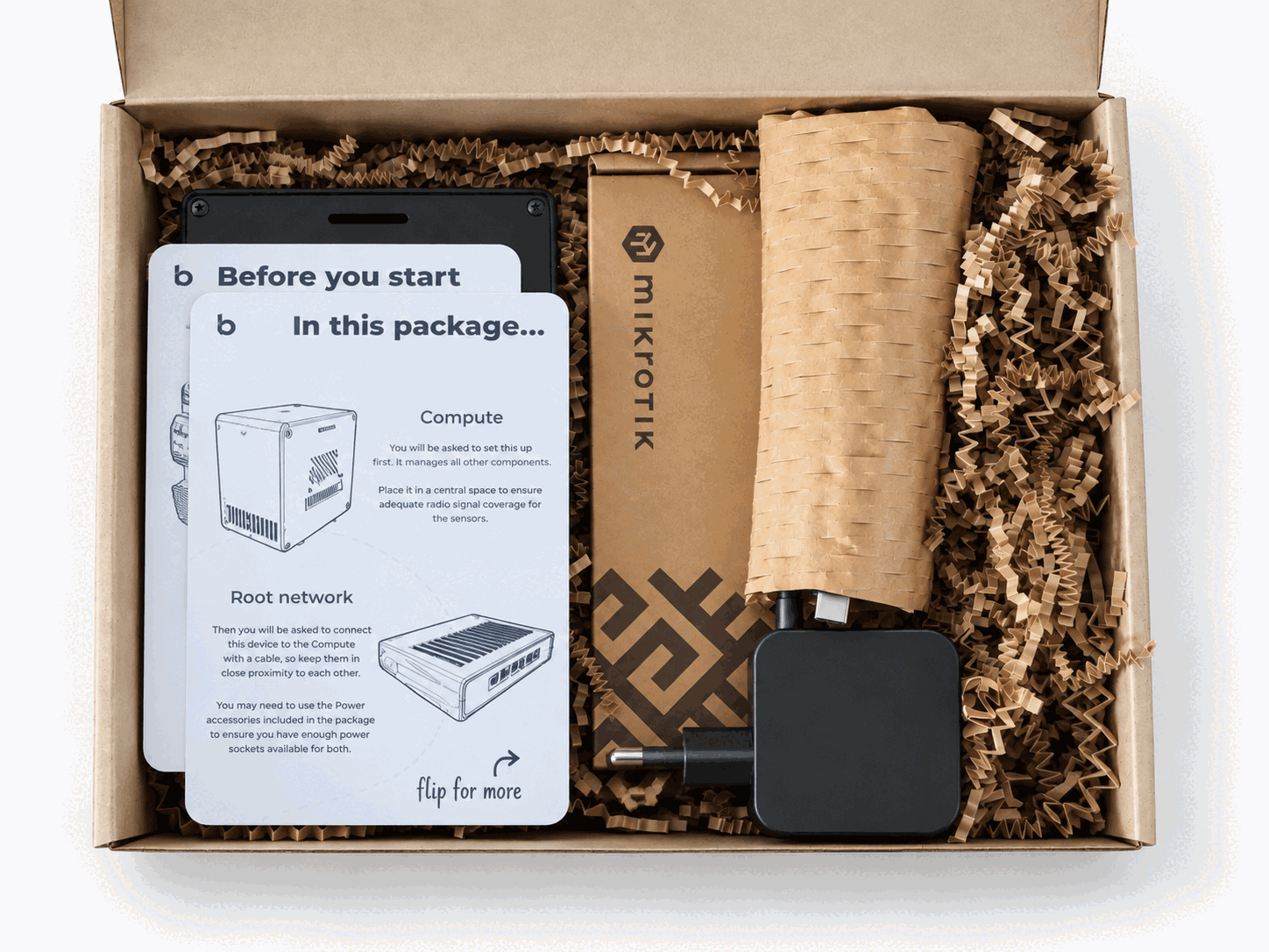 The Core ecosystem in its open box with hardware, power accessories, and printed setup cards.